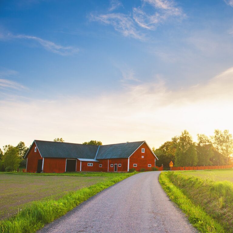 Rural scene with a barn at sunset.